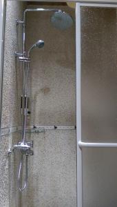 a shower with a shower head in a bathroom at 北竿議長的家Chairman's Villa in Beigan +7 photos
