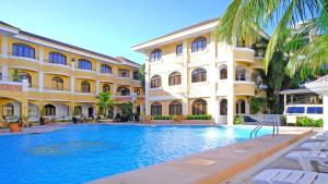 a hotel with a swimming pool in front of a building at Boracay Holiday Resort in Boracay