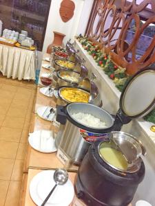 a kitchen counter filled with pots and pans of food at Boracay Holiday Resort in Boracay