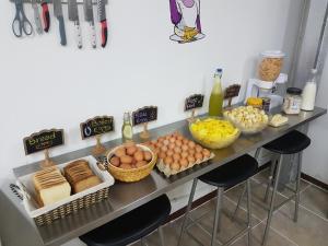 a table topped with lots of different types of pastries at Purple Monkey Hostel in Medellín