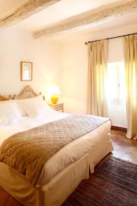 a bedroom with a large bed and a window at La Bastide De Moustiers - Hôtel et Restaurant - Teritoria in Moustiers-Sainte-Marie +50 photos