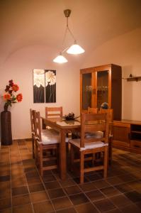 a dining room with a wooden table and chairs at Casa Sierpes in Cáceres