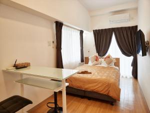 เตียงในห้องที่ M´s Stay Okinawa