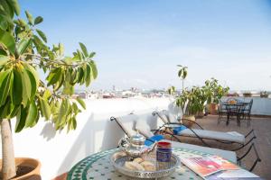 a table with a bowl of food on a balcony at Dar El Kébira in Rabat