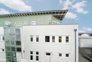 a building with a solarium on top of it at Pension Schweizer in Laupheim