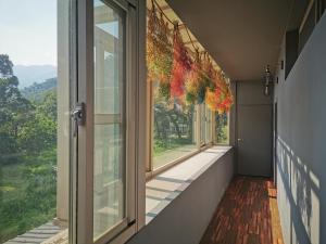 an empty hallway with a window with a view at Slow Wow Hot Spring Hotel in Jiaoxi
