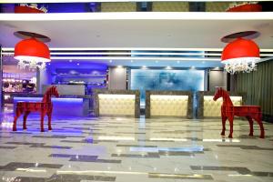 two red horses are standing in a restaurant at FX Hotel Tainan in Tainan