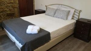a bedroom with a large bed and a dresser at House Diogo in Bemposta