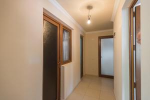 an empty hallway with a door and a window at Guesthouse Gorgasali 57 in Batumi