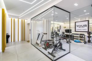 a gym with a glass wall with a gym equipment at Nsplace in Athens