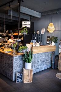 a woman is behind the counter of a restaurant at Frühstückshotel Fürstenwerth in Wilhelmshaven