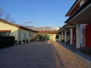 an empty street with mountains in the background at Merlo d'Oro in Carrara