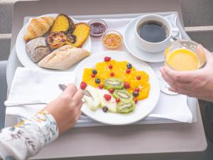 a tray with a plate of food and a cup of coffee at Hotel Baia in Cascais