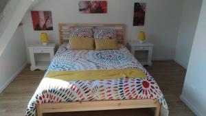 a bedroom with a large bed with two night stands at Au galet bleu in Dieppe