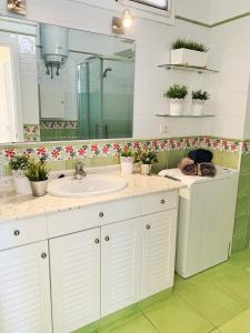 a bathroom with a sink and a mirror and flowers at relax in Candelaria