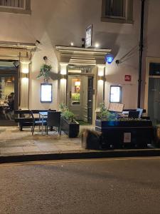 a building with a table outside of it at night at No12 Hotel in North Berwick