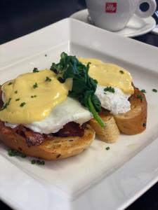 a sandwich with eggs and greens on a plate at No12 Hotel in North Berwick