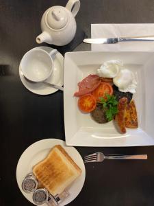 a plate of food with eggs and toast on a table at No12 Hotel in North Berwick