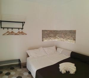 a bedroom with a bed with a pillow on it at casa concordia in Cefalù
