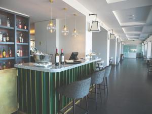 a bar in a restaurant with chairs and bottles of wine at Hotel Baia in Cascais