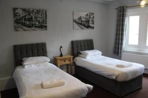 a bedroom with two beds and a window at The Royal Oak in Settle