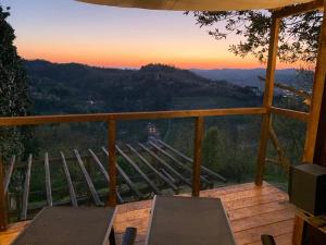 a view from the deck of a house with a sunset at Borgo Inferiore 24 in Acqui Terme