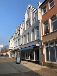 a building on a street with a sign in front of it at Stangenberg`s Dachschlösschen in Hameln