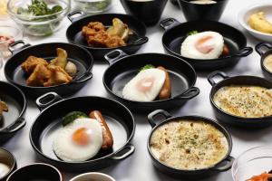 a group of bowls of food on a table at Dormy Inn Kawasaki Natural Hot Spring in Kawasaki