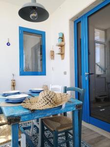 a blue table with chairs and a blue door at Casa vista Mare in Torre Canne