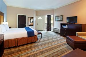 a hotel room with a bed and a flat screen tv at Holiday Inn Express Benicia by IHG in Benicia