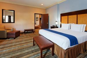 a hotel room with a large bed and a chair at Holiday Inn Express Benicia by IHG in Benicia +37 photos