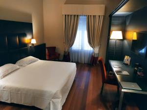 Postel nebo postele na pokoji v ubytování Hotel Porta Felice & Spa