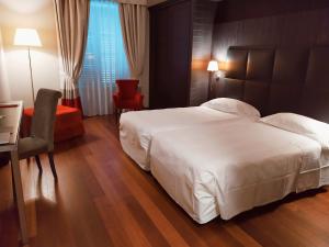 Postel nebo postele na pokoji v ubytování Hotel Porta Felice & Spa