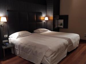 Postel nebo postele na pokoji v ubytování Hotel Porta Felice & Spa