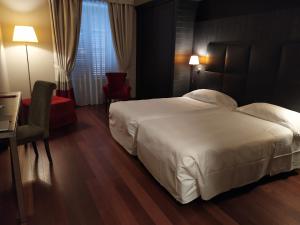 Postel nebo postele na pokoji v ubytování Hotel Porta Felice & Spa