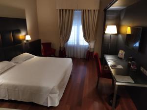 Postel nebo postele na pokoji v ubytování Hotel Porta Felice & Spa