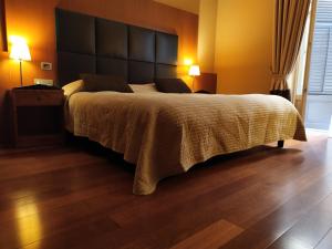 Postel nebo postele na pokoji v ubytování Hotel Porta Felice & Spa