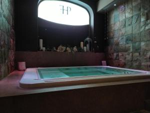 a bath tub in a bathroom with a window at Hotel Porta Felice & Spa in Palermo