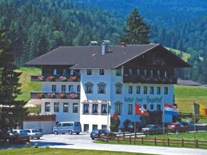 a large building with cars parked in front of it at Hotel Hagerhof in Thiersee