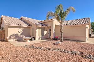 a house with a palm tree in front of it at Pet-Friendly Central Phoenix Home with Large Patio! in Phoenix