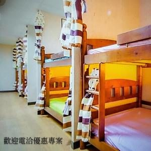 a row of bunk beds in a room at Non-profit bee home in Keelung