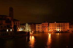 a view of a river at night with buildings at B&b Vista sul Canal Grande in Venice