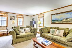 a living room with two couches and a table at 2 Mi to Shore Home with BBQ and Beach Gear in Mashpee in Mashpee