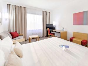 a hotel room with a bed and a desk at Novotel Katowice Centrum in Katowice
