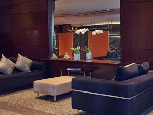 a living room with two couches and a coffee table at Mercure Sao Paulo Paulista in São Paulo