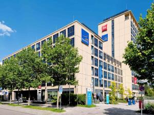 a large building with a sign on the side of it at ibis München Parkstadt Schwabing in Munich