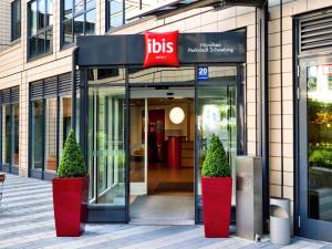 a store front with two potted trees in front of it at ibis München Parkstadt Schwabing in Munich