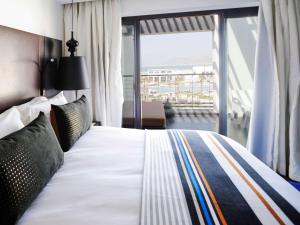 a bedroom with a large bed with a large window at Sofitel Agadir Thalassa Sea & Spa in Agadir