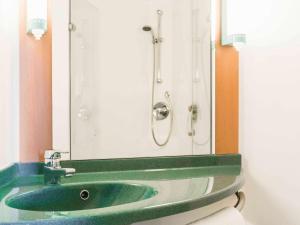 a bathroom with a green sink and a mirror at ibis Leeds Centre Marlborough Street in Leeds