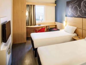 Ein Bett oder Betten in einem Zimmer der Unterkunft ibis Macae